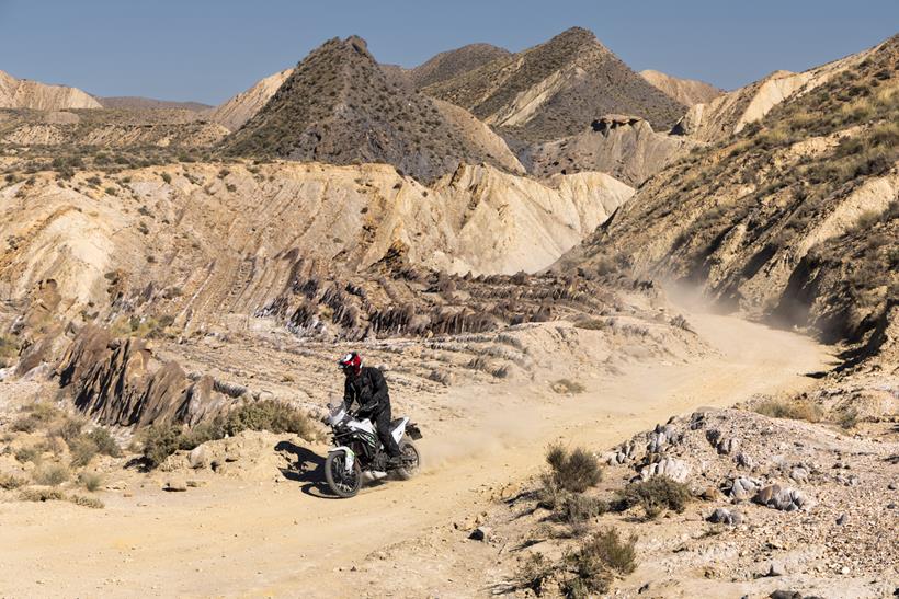 2026-on Kawasaki KLE500 wide shot of riding a dusty track